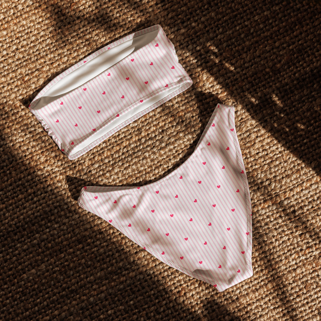 Striped heart print recycled bandeau bikini top and high-leg bottoms on a neutral background