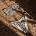 Vintage wildflower print recycled bandeau bikini top and bottoms with soft floral design on neutral background