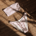 Striped heart print recycled bandeau bikini top and high-leg bottoms on a neutral background