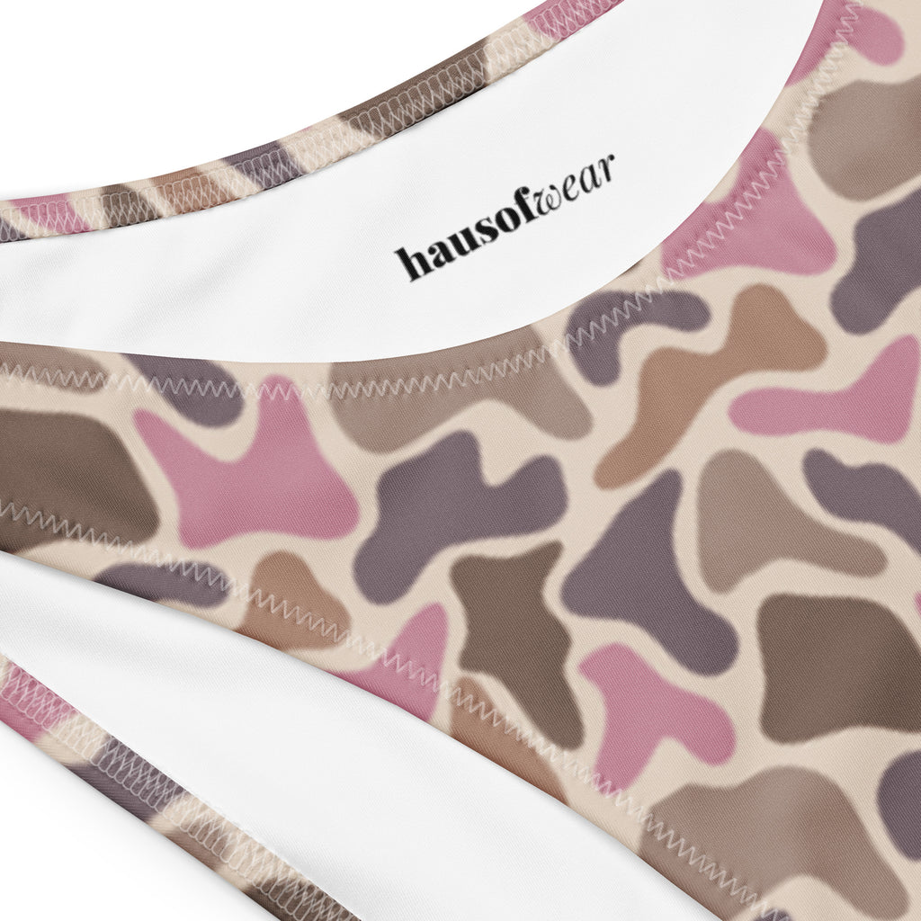 Old school pink camo recycled bandeau bikini top and high-leg bottoms on a natural background