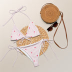 Striped heart all-over print recycled string bikini with adjustable tie straps on a clean background