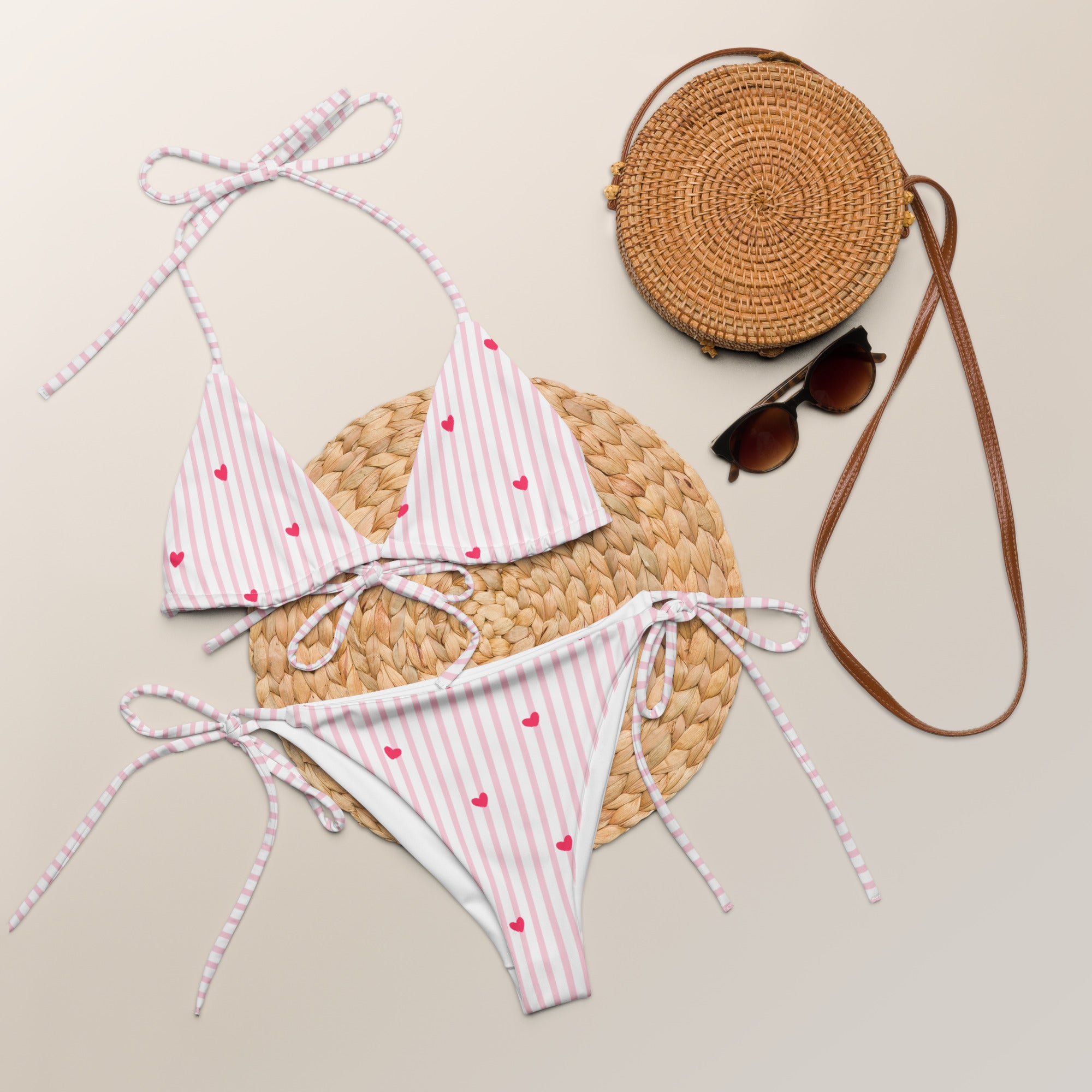Striped heart all-over print recycled string bikini with adjustable tie straps on a clean background