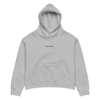 Women's relaxed fit hoodie displayed in a cozy flat lay on a neutral background