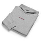 Women's relaxed fit hoodie displayed in a cozy flat lay on a neutral background