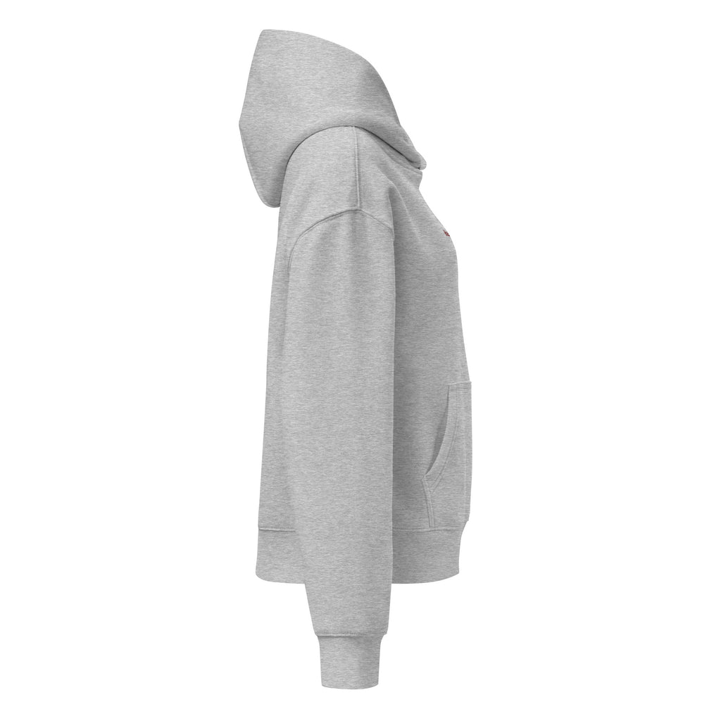 Women's relaxed fit hoodie displayed in a cozy flat lay on a neutral background