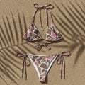 Camouflage-patterned bikini set on a sandy background