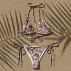 Camouflage-patterned bikini set on a sandy background