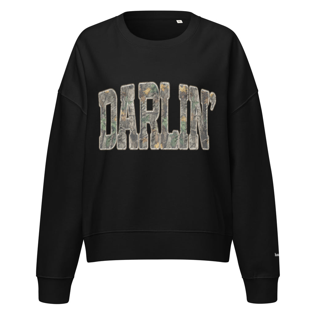Darlin' script graphic women's organic crew neck sweatshirt in a cozy flat lay setup