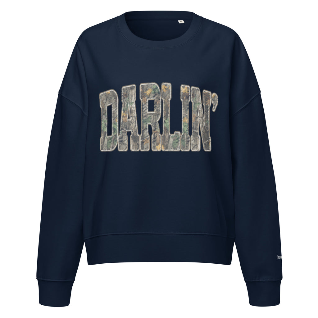 Darlin' script graphic women's organic crew neck sweatshirt in a cozy flat lay setup